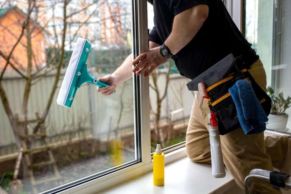 a man professionally cleaning windows